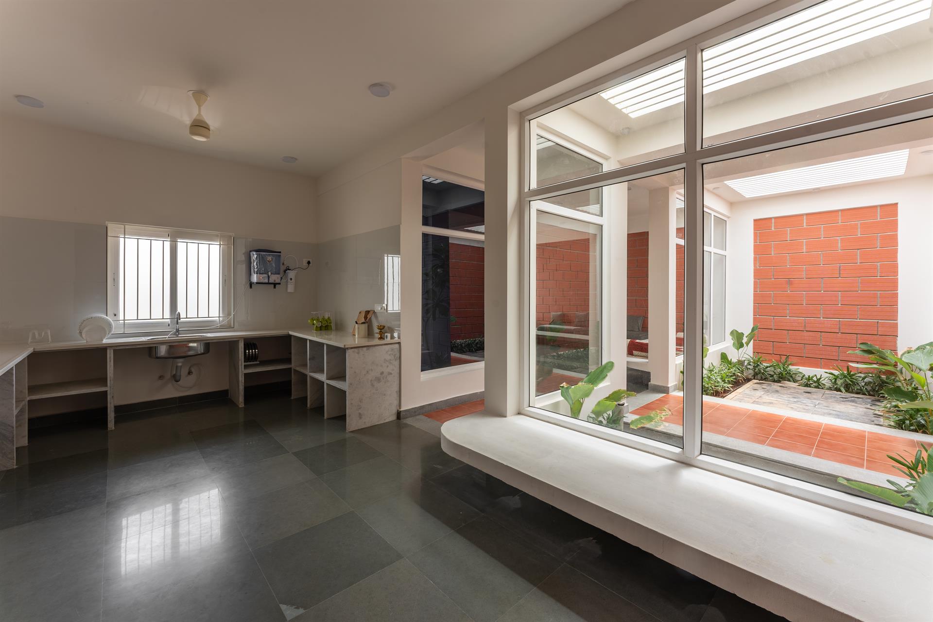 OXO House — Kitchen with panoramic courtyard window